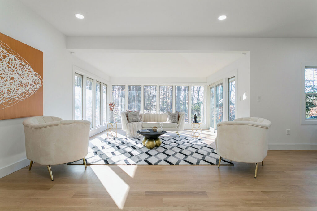 designing, renovations, One Horizon, NJ, New Jersey, general contractor, home construction, home contractor, new home construction, house developer, living room, white couches and chairs, patterned rug, accent table, windows, wooden floors