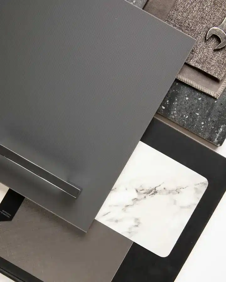 Interior material samples: dark metal, marble and textiles